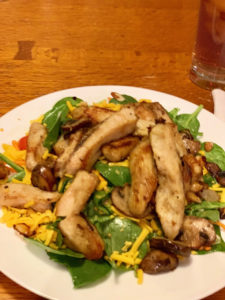 Image of grilled chicken salad and spinach on plate